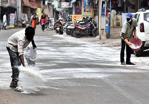 Poonamallee Municipality staff spraying bleaching powder to prevent CORONA on Monday in Chennai. (Photo | P Jawahar/EPS)