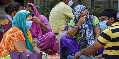 Relatives of a COVID-19 victim mourn outside a government hospital as they wait to receive his body during the fifth phase of COVID-19 nationwide lockdown in New Delhi Monday June 8 2020. (Photo | PTI)
