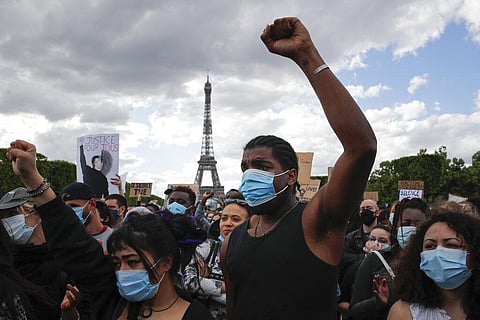 Hundreds of demonstrators gather on the Champs de Mars as the Eiffel Tower is seen in the background during a demonstration in Paris to protest against the recent killing of George Floyd, a black man who died in police custody in Minneapolis, U.S.A., afte