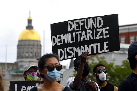 A protester's sign is shown at Peachtree Plaza during a demonstration Saturday, June 6, 2020, in downtown Atlanta. Protesters were demonstrating against the death of George Floyd, who died after he was restrained by Minneapolis police on May 25. (Photo | 