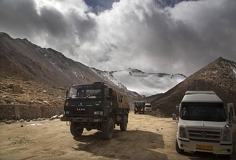 In this September 14, 2018, photo, an Indian Army truck crosses Chang la pass near Pangong Lake in Ladakh region, India. Indian and Chinese soldiers are in a bitter standoff in the remote and picturesque Ladakh region, with the two countries amassing sold