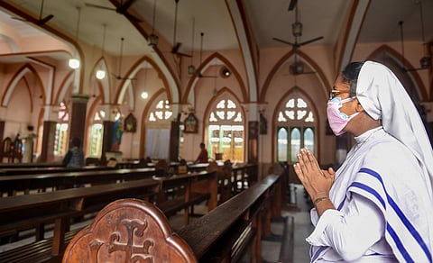 A nun wearing a face mask offers prayers at a church after the authorities permitted opening of all religious places with certain restrictions during the fifth phase of COVID-19 nationwide lockdown in Kolkata Monday June 8 2020. (Photo | PTI)