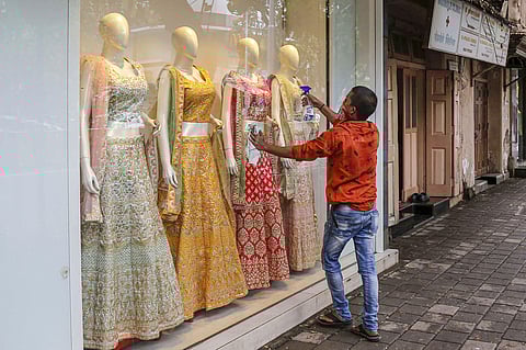 A worker cleans the entrance of a shop during the fifth phase of COVID-19 nationwide lockdown at Dadar in Mumbai Monday Jan 8 2020. (Photo | PTI)
