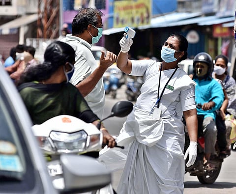 An ANM checks the tempareture of a person at Poonamalai on Monday in Chennai. (Photo | P jawahar/EPS)