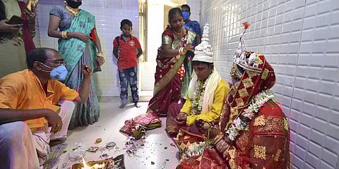 A couple take part in traditional rituals during their marriage ceremony at a priest's house near Kalighat Kali temple in Kolkata. (File photo| PTI)