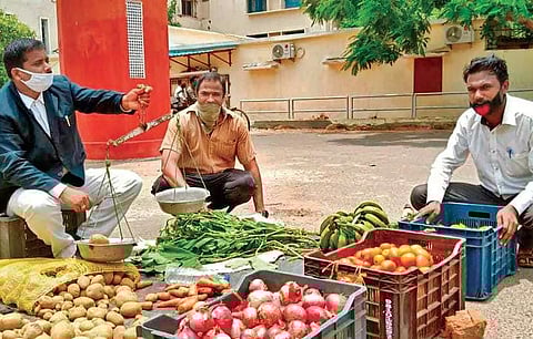 Sapan Kumar Pal selling vegetables in front of High Court on Thursday (Photo | EPS)