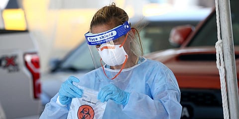 A specimen is secured at a drive-thru coronavirus testing site at South Mountain Community College in Phoenix, Arizona. (File photo| AP)