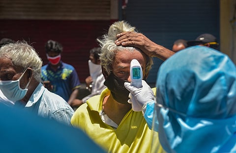 Volunteers conduct thermal screening at Dharavi during the ongoing COVID-19 lockdown in Mumbai. (Photo | PTI)
