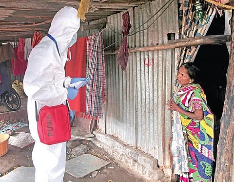 A healthcare worker takes updates from a woman in Mumbai | PTI