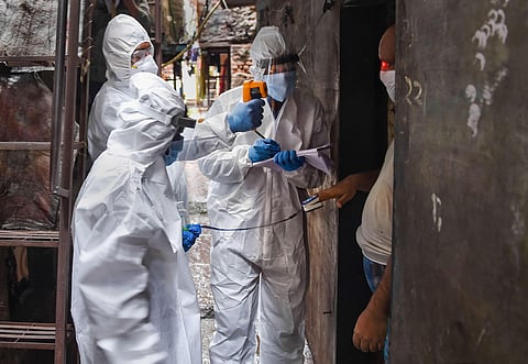 Health workers wearing PPE kits conduct door-to-door medical check-up of the residents of Dharavi slum amid COVID pandemic in Mumbai Thursday July 9 2020. (Photo | PTI)