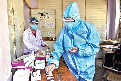 A medic sorts samples for rapid antigen testing in New Delhi (Photo | PTI)
