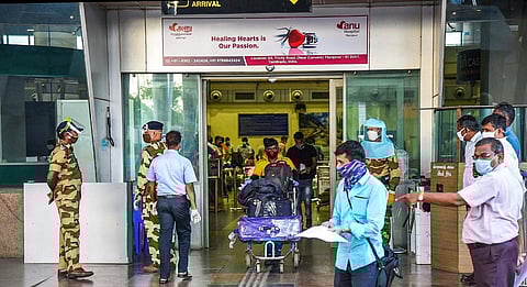 Rescue flight passengers coming out of the airport terminal building after the document verification and swab collection in Tiruchy airport. (Photo | MK Ashok Kumar, EPS)