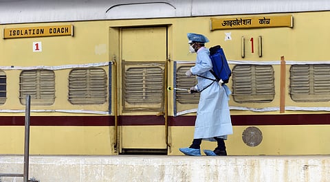 A health worker sprays disinfectant on railways coaches modified into isolation wards to take care of COVID-19 cases at Shakurbasti in New Delhi on Thursday June 25 2020. (Photo | Parveen Negi/EPS)