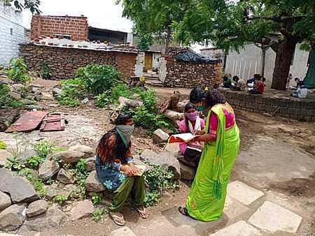 A teacher teaching students at Neelakhed village of Kalaburagi on Monday (Photo | Express)