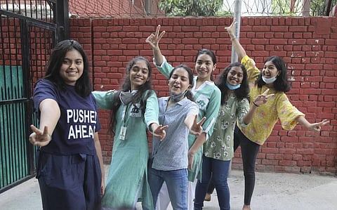 Students celebrate after CBSE declared class 10th results during Unlock 2.0 in New Delhi on Wednesday. (Photo | PTI)