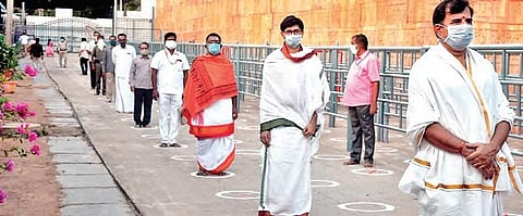 Maintaining physical distance, Srisailam temple staff stand in a queue. (File photo| EPS)