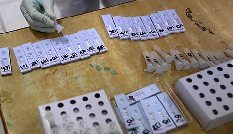 A medical technician collects swab samples for coronavirus COVID-19 Rapid Antigen detection testing in New Delhi on Tuesday. (Photo | Shekhar Yadav/EPS)