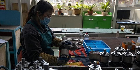 In this April 13, 2020, file photo, a worker assembles gearboxes at the Kofon factory in Huanggang in central China's Hubei province.. (Photo | AP)