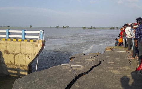 People stand near the washed away part of the newly-built Sattarghat Bridge following heavy rainfall in Gopalganj Wednesday July 15 2020. (Photo | PTI)