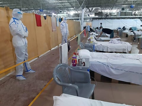 Patients perform yoga inside at the Radha Soami Satsang Beas Center, temporarily converted into a COVID-19 coronavirus care centre, in New Delhi on Friday. (Photo | EPS)