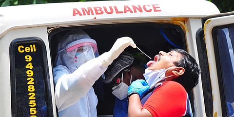 Medical personnel conducting COVID-19 test at ENT govt hospital in Visakhapatnam. (Photo | G Satyanarayana, EPS)