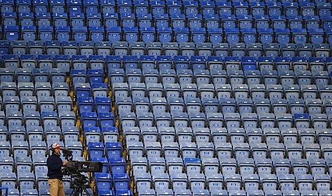 In this Tuesday, July 14, 2020 file photo, a television cameramen films in front of the empty stands. (Photo | AP)