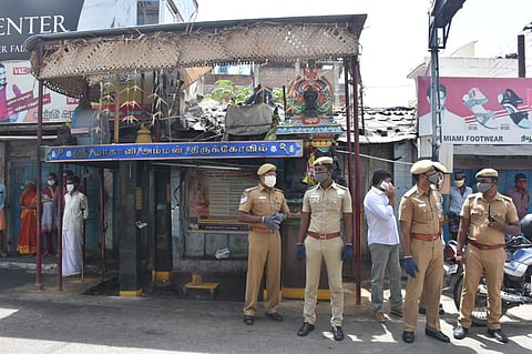 Miscreants burnt clothes and tyres at Magaliamman temple on NH road near Five Corners in Town Hall in the city. (Photo | U Rakesh Kumar, EPS)