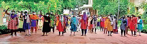 The outsourced nurses protest outside the Director’s office at NIMS in Hyderabad on Friday
