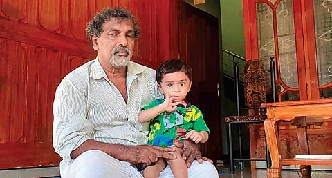 Sitting on the lap of his grandfather  Abdulla at their house in ​Udumbunthala at Trikaripur, son of Mohammed Aslam O T