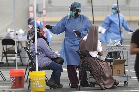 In this Monday, July 6, 2020 file photo, a health care worker administers a COVID-19 test at a site sponsored by Community Heath of South Florida at the Martin Luther King Jr. Clinica Campesina Health Center in Homestead, Fla. (Photo | AP)