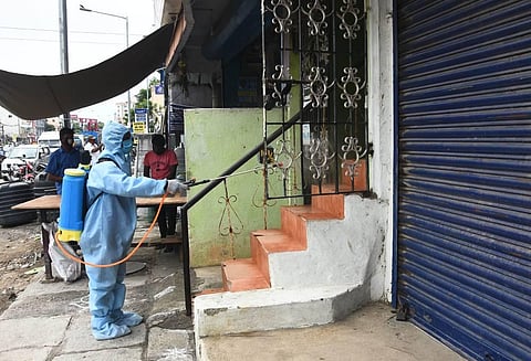 A Chennai corporation staffer sanitises shops and homes in the city. (Photo | Ashwin Prasath, EPS)