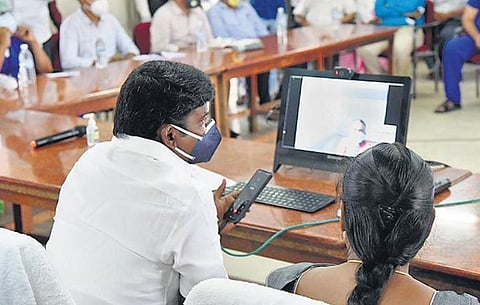 Health Minister C Vijaya Baskar interacts with a Covid-19 patient through video call at Tirunelveli medical college on Saturday | V KARTHIK ALAGU