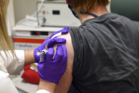 In this May 4, 2020 photo provided by the University of Maryland School of Medicine, the first patient enrolled in Pfizer's COVID-19 coronavirus vaccine clinical trial at the University of Maryland School of Medicine in Baltimore, receives an injection. (