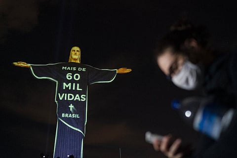 The Christ the Redeemer statue is lit up with a message that reads in Portuguese; 'More than 60 thousand lives Brazil' in reference to the people who have died from COVID-19 in the country, in Rio de Janeiro, Brazil, Wednesday, July 1, 2020. (Photo | AP)
