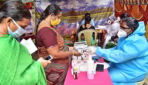 Local residents receiving medication at a medical camp held for COVID - 19 at Tondiarpet on Wednesday in Chennai. (Photo | P Jawahar/EPS)