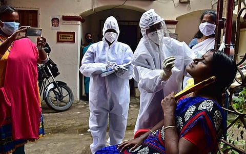 A medical team take the swab test to find Corona at a street off Kummallamman Koil street Tondiarpet on Thursday in Chennai. (Photo | P Jawahar, EPS)