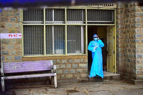 A health worker on break at a fever clinic on JC Road in Bengaluru. (Photo | Pandarinath B/EPS)