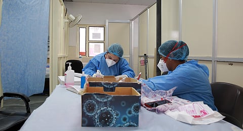Health official labels rapid test kits at a Covid-19 rapid antigen testing Centre. (Photo | Shekhar Yadav, EPS)