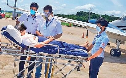 The patient being checked by on-ground medical staff upon landing in Kochi