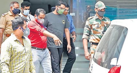 The NIA team, along with gold smuggling case accused Sarith Kumar,  leaving a residential apartment near Secretariat in Thiruvananthapuram  after evidence collection on Tuesday | B P Deepu