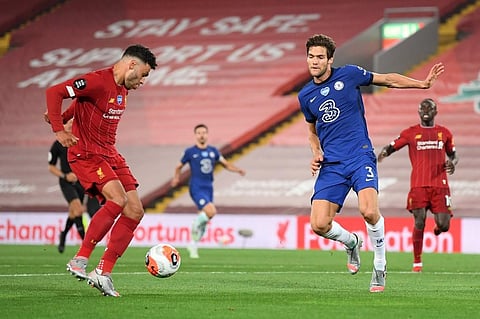 Liverpool's English midfielder Alex Oxlade-Chamberlain (L) scores his team's fifth goal during the English Premier League football match between Liverpool and Chelsea at Anfield. (Photo | AFP)