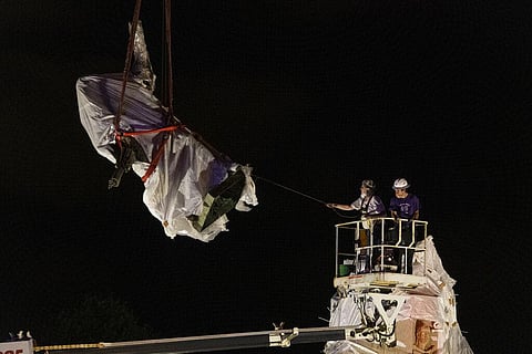 City municipal crews help guide the Christopher Columbus statue in Grant Park as it is removed by a crane, Friday, July 24, 2020, in Chicago. (Photo | AP)