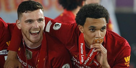 Liverpool's Trent Alexander-Arnold, right with Liverpool's Andrew Robertson, pose for the cameras following the presentation of the English Premier League trophy. (Photo | AP)