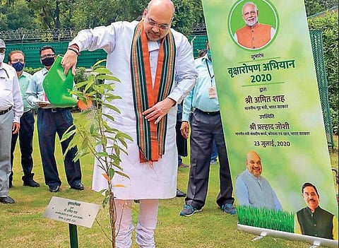 Home Minister Amit Shah waters a ‘Rudraksha’ sapling during the inauguration of Plantation Campaign 2020 and foundation laying ceremony of 6 Eco Parks, organised by Ministry of Coal in New Delhi (PTI)