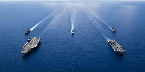 Aircraft carrier USS Ronald Reagan (CVN 76)(L) and the amphibious assault ship USS Boxer (LHD 6) along with other US naval ships conduct security and stability operations in the South China Sea. (File