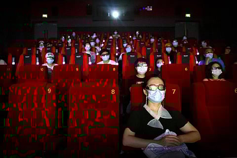 People wearing face masks to protect against the coronavirus sit spaced apart as they watch the film 'Dolittle' at a movie theater in Beijing, Friday, July 24, 2020. (Photo | AP)