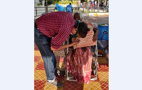 SVIMS superintendent Dr R Ram seeking blessings of the woman after her discharge from Covid-19 hospital. (Photo | EPS)