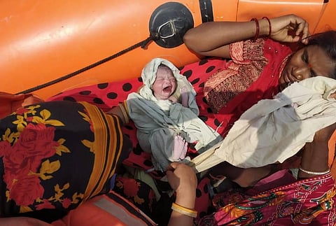 Rima Devi with her newborn on an NDRF rescue boat in East Champaran district of Bihar (Photo | Express)