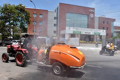 Sanitary stadd spraying disinfectant at ESI Hospital in Coimbatore on Sunday. (Photo | U Rakesh Kumar, EPS)