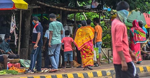 Violating social distance norms locals buying fish from a roadside vendor near Khandagiri square during lockdown in Bhubaneswar on Friday. (Photo | Biswanath Swain/EPS)